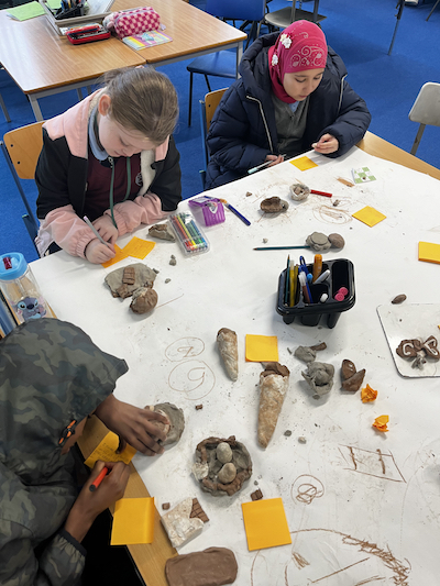 Children discussing and creating artworks. Anti racism education (Children's Parliament 2024)