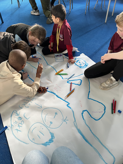 Children discussing and creating artworks. Anti racism education (Children's Parliament 2024)